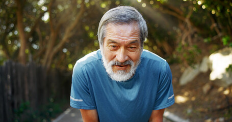 Tired, runner and senior asian man in nature for workout fatigue, health and intense cardio. Wellness, retirement and fitness with elderly person outdoor for exercise burnout, resting and breathing