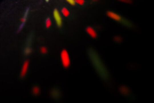 Soft, out-of-focus red and green light trails shine against a dark background, creating a moody effect. Grainy Noise Texture