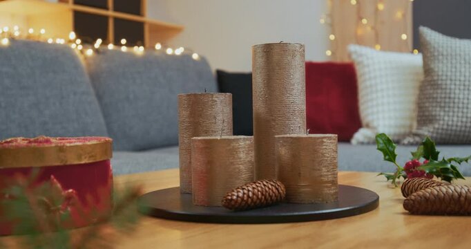 Christmas Home Decorations &ndash; Woman Lighting Modern Golden Candles on Advent Arrangement
