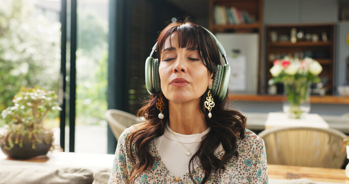 Calm, headphones and woman on sofa in home for relax, zen or peace in living room in morning. Breathing, audio tech and female person listening to guided meditation for spiritual wellness or health. - Powered by Adobe