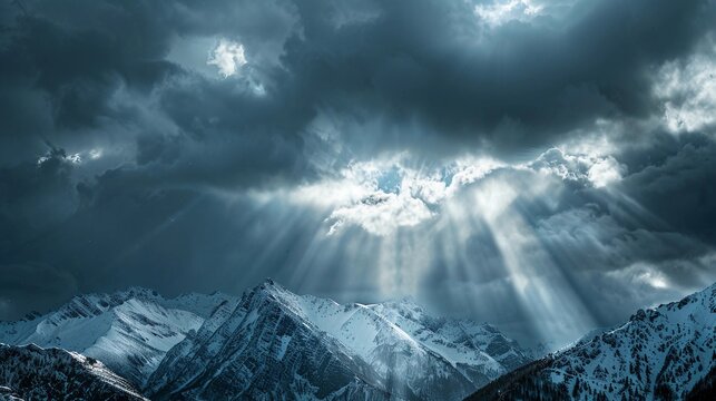 Majestic mountain landscape with dramatic clouds and sunlight breaking through during early morning hours