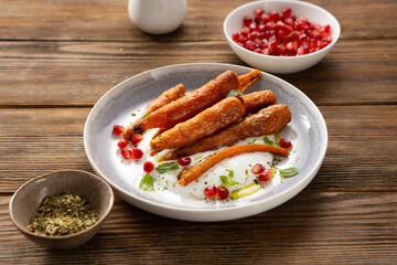 Close up of roasted baby carrots on plate