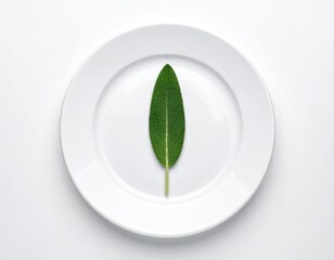 Sage leaf centered on bright white plate, minimal composition