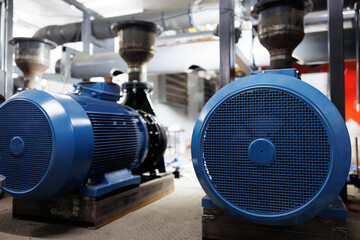Industrial machinery showcased in a factory setting with blue motors and equipment