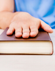 Hand on the Book closeup