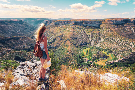 Hiker woman enjoying beautiful mountain and valley landscape. Cirque de navacelles in France