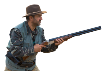 Hunter man in camouflage with a gun during the hunt in search of wild birds or game. Autumn hunting season.