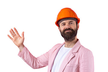 Portrait of young construction engineer wear orange hard hat, in a pink jacket standing on red studio background. The man points with his hand.