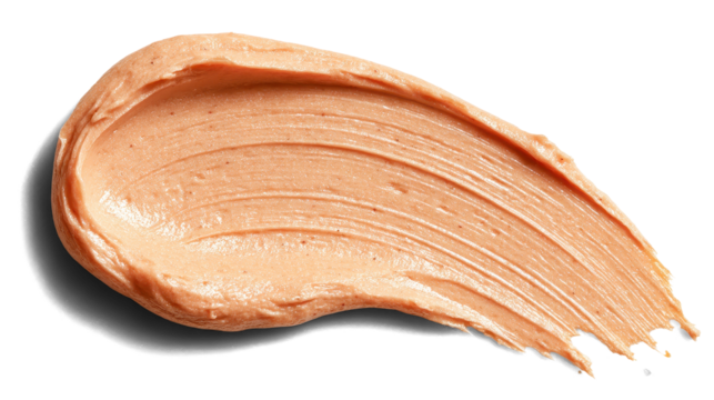 Apricot-tinted sunscreen smear, creamy lotion texture with slight glow isolated on white background. Transparent background