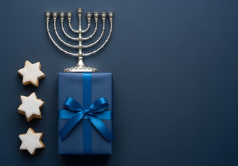 Elegant Hanukkah holiday flat lay with menorah, gift, and star cookies