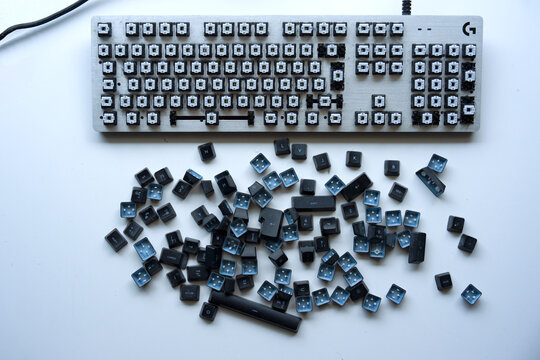 Top view of Logitech dusty gaming keyboard type G413 silver with keys removed against white background. Photo taken November 25th, 2025, Zurich, Switzerland.
