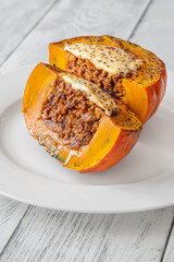 Portion of baked Hokkaido pumpkin with beef, tomato sauce, mozzarella cheese