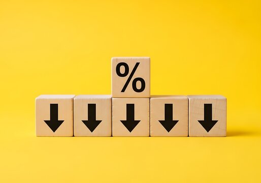 Wooden blocks with a percentage symbol and down arrows illustrating a decrease in interest rates or economic decline