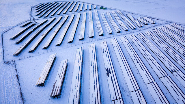 Snowy photovoltaic farm in winter. Alternative energy in Poland.