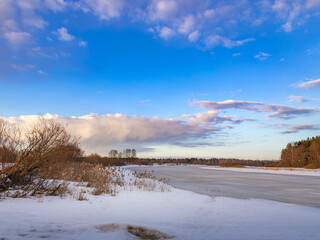 Snowy landscape with a blue sky and a few trees