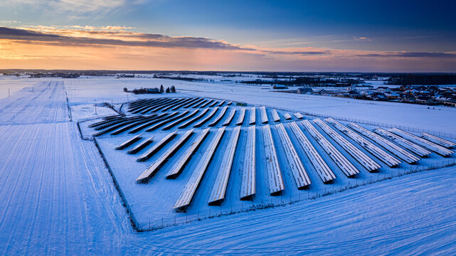 Snowy solar panels. Frozen solar panels in winter. Alternative energy.