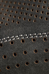 dark smooth perforated leather for shoe , a large number of equal holes in natural leather for shoe production