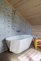 a freestanding bathtub in a bathroom in a log country house
