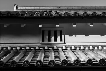 光と影が描き出す伝統的な町家の虫籠窓と瓦屋根の構造美