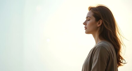 Profile of beautiful woman sitting and meditate on white background  - focus on mind and body to achieve mentally clear calm and emotionally stable state