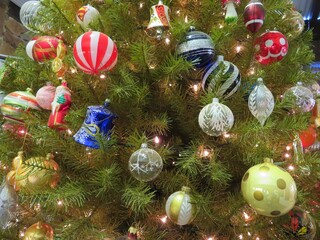 christmas tree with handmade glass decorations of different shapes