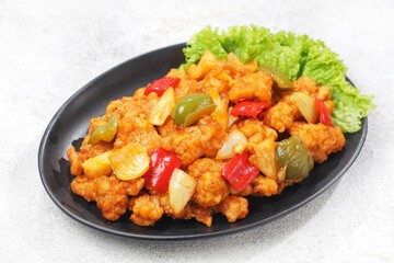 Ayam Asam Manis. Sweet and sour chicken is a Cantonese specialty often found on Chinese restaurant menus.