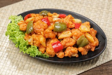 Ayam Asam Manis. Sweet and sour chicken is a Cantonese specialty often found on Chinese restaurant menus.