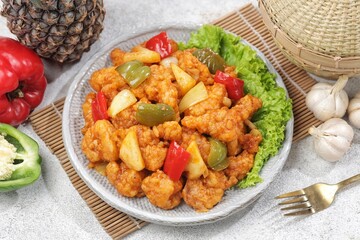 Ayam Asam Manis. Sweet and sour chicken is a Cantonese specialty often found on Chinese restaurant menus.