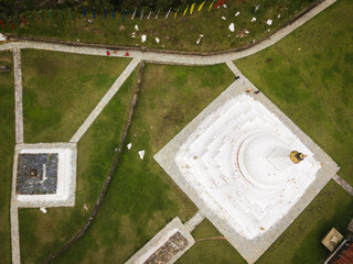 Aerial view of the Chendebji Chorten Stupa's radiant white form contrasts against the verdant green landscape, a serene beacon of spirituality, Chendebji village, Trongsa, Bhutan.