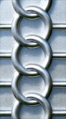 A close-up view of several interlocking metal chain links against a textured, light gray background. The lighting is cool and highlights the metallic sheen of t