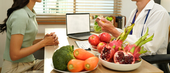 Dietician, male nutrition specialist consulting woman, developing healthy diet, dietary program. Dietary consultant asking, giving male patient advice, help, nutritional information, new meal plan