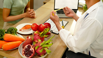 The healthcare professional providing nutritional guidance to a patient, developing healthy diet, dietary program. Dietary consultant asking, giving female patient advice, help