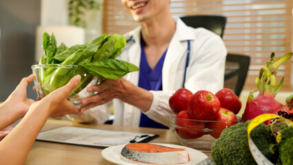 Nutritionist giving consultation to patient with healthy fruit and vegetable, Right nutrition and diet concept