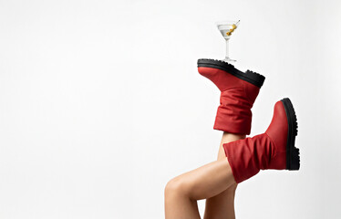 Whimsical Red Boots Lifestyle: Martini Balance on Playful Upside-Down Legs. Winter, Christmas or New Year Concept