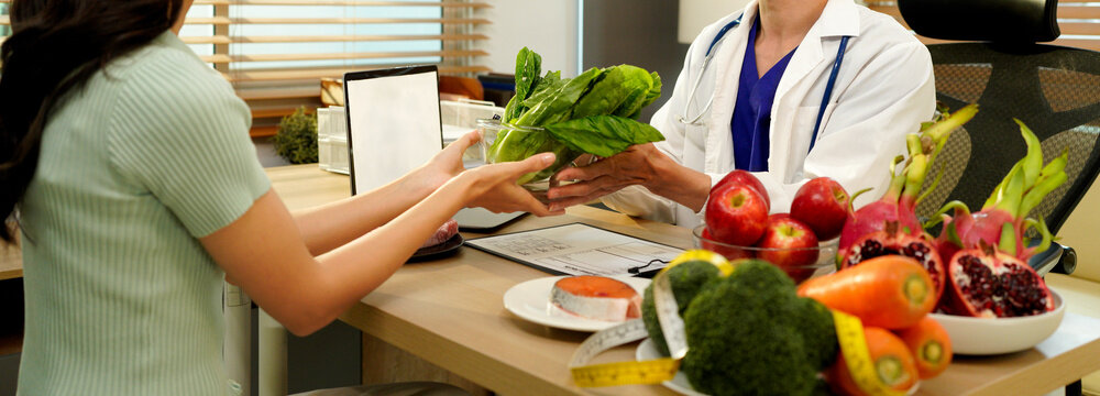 The healthcare professional providing nutritional guidance to a patient, developing healthy diet, dietary program. Dietary consultant asking, giving female patient advice, help