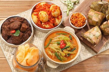 Ketupat Lebaran atau Eid Ketupat. The dishes served during Eid al-Fitr and Eid al-Adha are Ketupat, Opor Ayam, Rendang, Telur Balado, Sayur Labu Siam, and Sambal Goreng Hati. Selective Focus .