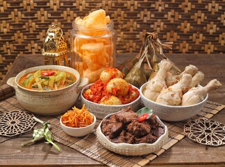 Ketupat Lebaran atau Eid Ketupat. The dishes served during Eid al-Fitr and Eid al-Adha are Ketupat, Opor Ayam, Rendang, Telur Balado, Sayur Labu Siam, and Sambal Goreng Hati. Selective Focus .