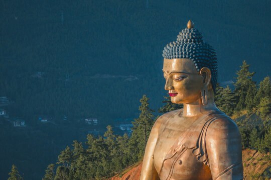 Aerial view of the golden Buddha Dordenma statue, a beacon of tranquility, standing tall against the backdrop of lush green hills, Thimphu, Thimphu, Bhutan.