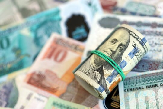 Egyptian pound currency money bills and bunch of us dollar banknotes close up. The concept of economics and currency exchange