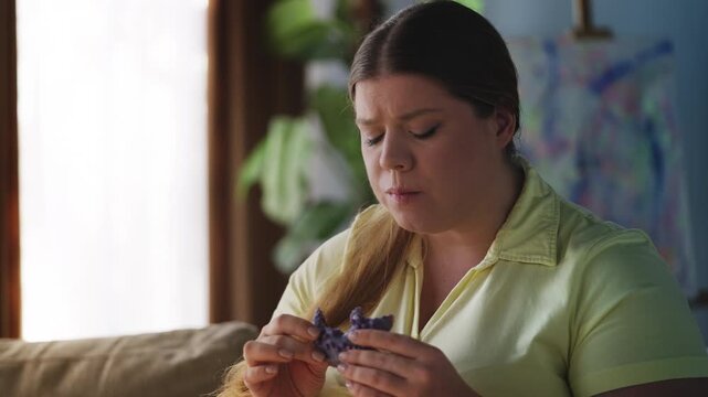 Lonely plus size woman eating donut, dealing with sugar addiction and stress