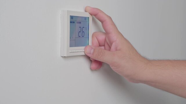 Adjust temperature at remote control with display for using air conditioner, close up. High quality 4k footage