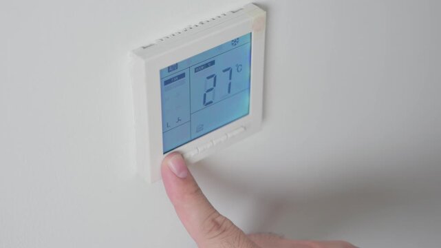 Adjust temperature at remote control with display for using air conditioner, close up. High quality 4k footage