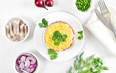 Layered salad with beet, herring, carrots and potatoes