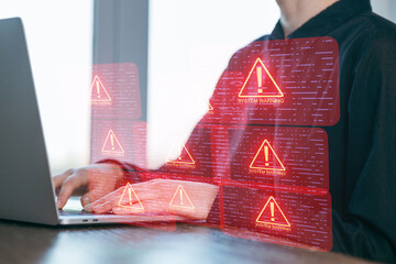 System warning alerts appearing while a person works on a laptop in a modern office setting