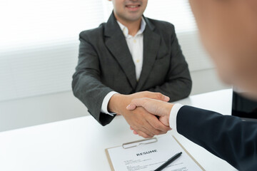 Executives accept job application and shake hand, documents and job applicants resume to match the...