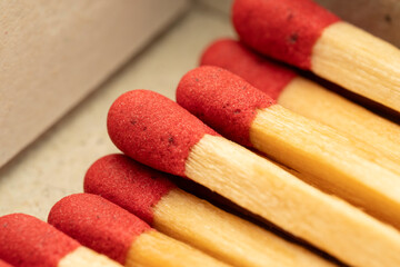 Extreme Close-up Macro of Red Matchstick Heads and Wood Texture on Clean White Background