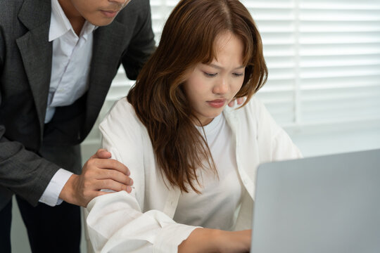 business man sexually harassed a female colleague by touch her shoulder. Sexual harassment in office. Women feel anxious and stressed from being harassed. molest, assault, inappropriate