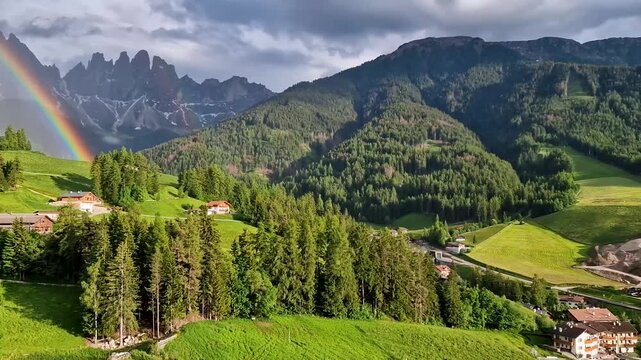 Italy, south Tyrol. Breathtaking Dolomites - most beautiful mountains in Alps, UNESCO site. Unique video with rainbow. Beautiful valley Val di Funes after rain. .Alpine nature scenery