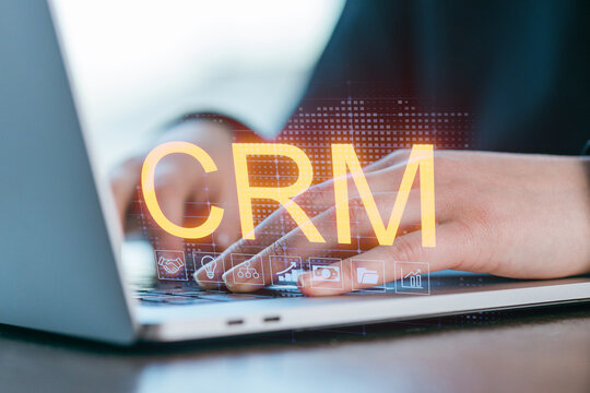 Utilizing customer relationship management software on a laptop for business efficiency