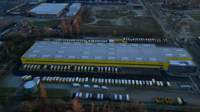 Long yellow DHL distribution center Berlin. Majestic aerial view flight drone